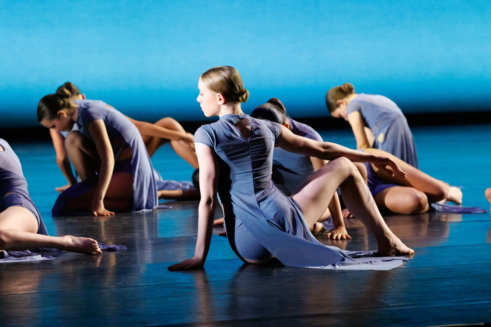Teen contemporary dancers performing on stage